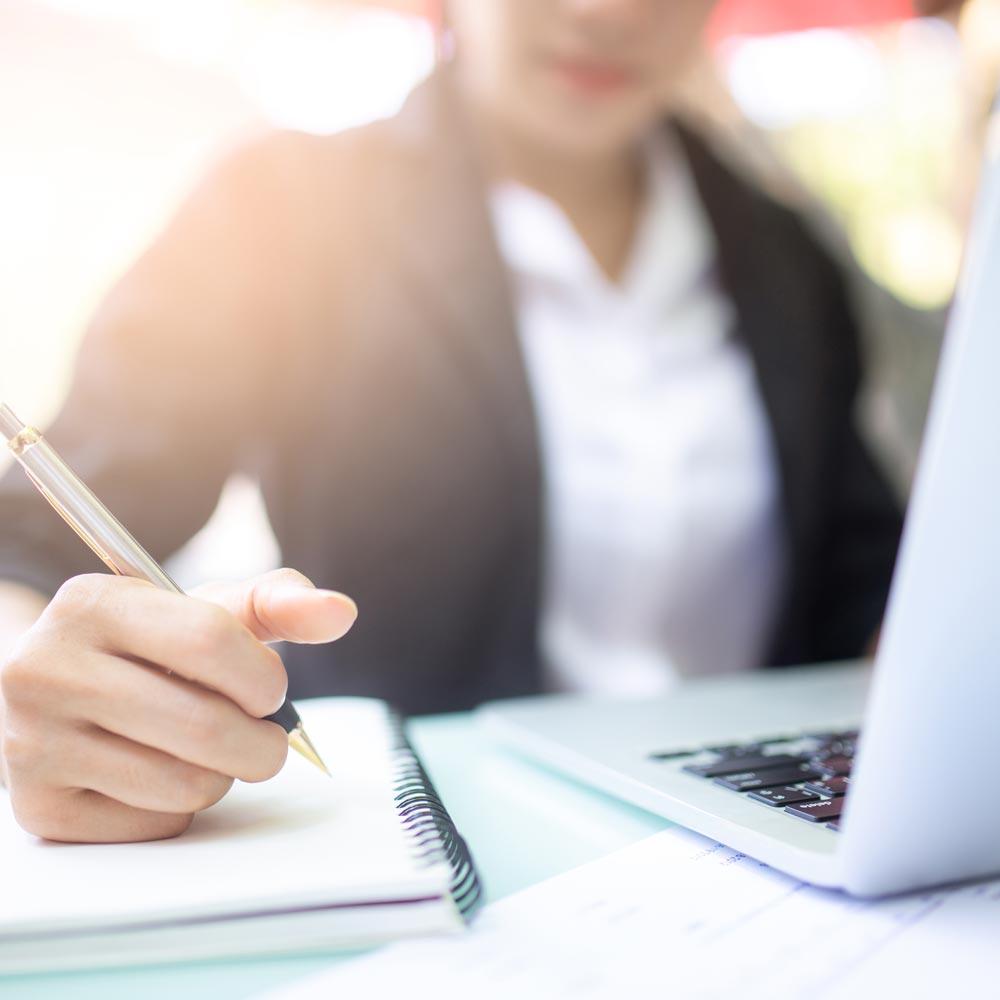 Woman writing valuation notes